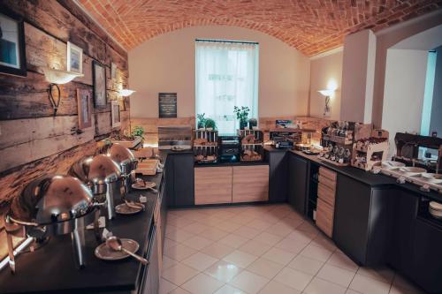 a large kitchen with sinks and a large window at Hotel Benaco in Desenzano del Garda