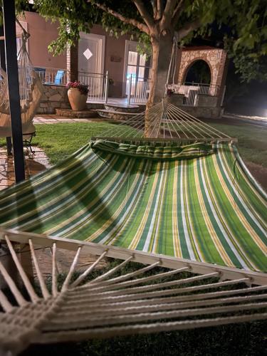 a hammock in the yard of a house at Mama’s Sunshine Garden Villa in Áyios Ilías