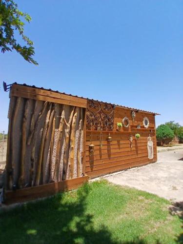 a wooden fence with a gate in the grass at Mama’s Sunshine Garden Villa in Áyios Ilías