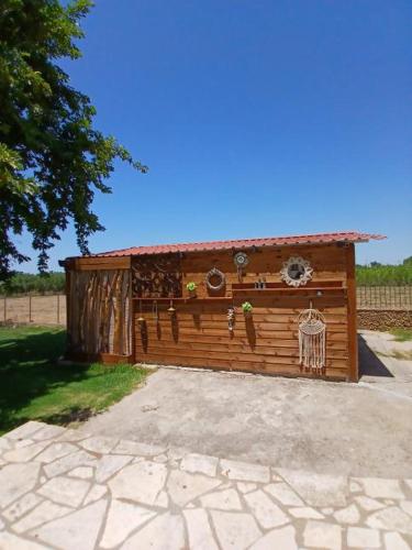 a wooden building with a fence in a yard at Mama’s Sunshine Garden Villa in Áyios Ilías