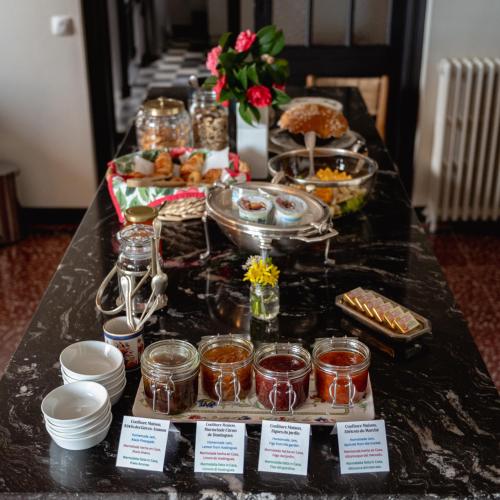 a long buffet of food on a table at L'écrin des Gaves in Hastingues