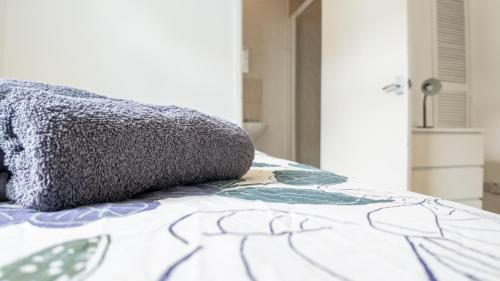 a bed with a pillow on top of it at Pebbles guest house room 3 in Southampton