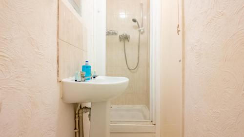 a white bathroom with a sink and a shower at Pebbles guest house room 3 in Southampton