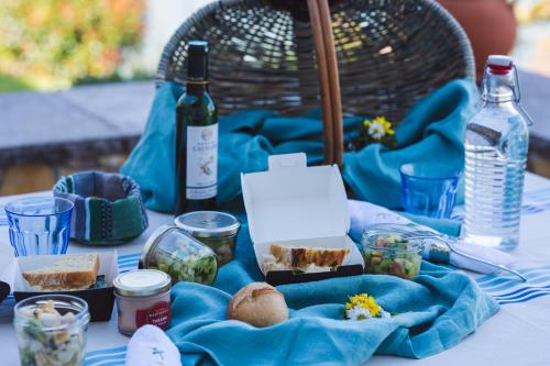 a table with food and bottles of wine on it at L'écrin des Gaves in Hastingues