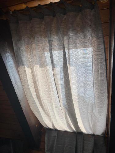 a window with white curtains in a room at Penzión Zátoka in Liptovský Mikuláš