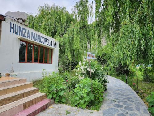 a building with a sign on the side of it at Hunza Marcopolo Inn Gulmit in Gulmit