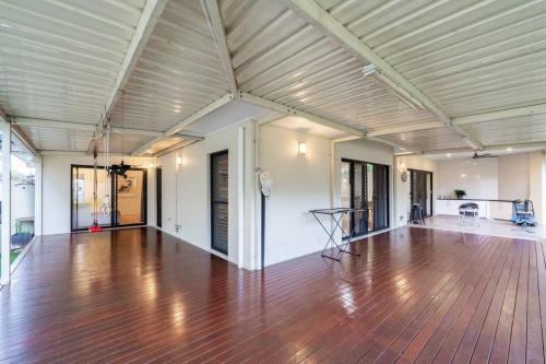 an empty living room with a wooden floor and a ceiling at Spacious 5BR 3BA Home w Parking and Yard in Sunnybank M11 in Brisbane