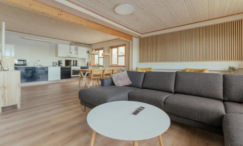 a living room with a couch and a table at Á Tromini Guesthouse in Tórshavn