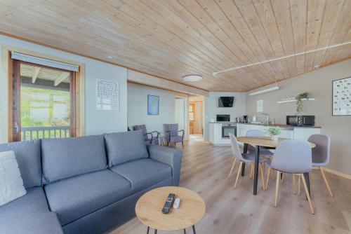 a living room with a couch and a table at Á Tromini Guesthouse in Tórshavn