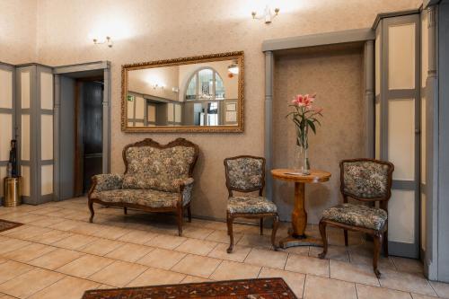 a living room with two chairs and a mirror at Villa Irena in Sopot