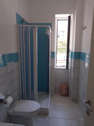 a bathroom with a toilet and a shower at Villa3 Cancelli Guesthouse B&B via del Mare Formia in Formia
