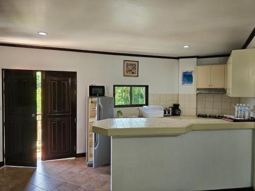 a kitchen with a counter top and a refrigerator at Sai Rougn apartment in Patong Beach