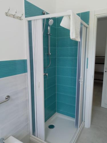 a bathroom with a shower with blue tile at Gianola Residence Monolocali Formia in Formia