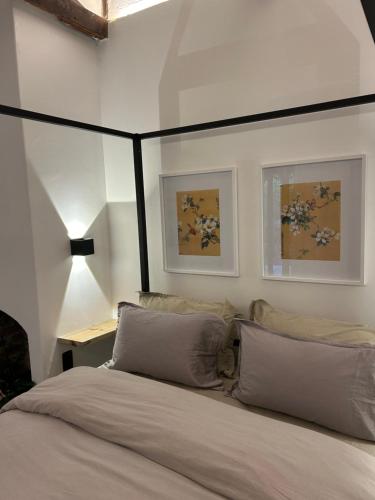 a bedroom with a bed with a black canopy at Urban Plett in Plettenberg Bay