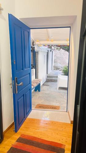 a blue door in a room with a hallway at LimonoSpito in Koroni