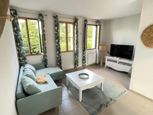 a living room with a couch and a table at La Véranda de la mouette in Thonon-les-Bains