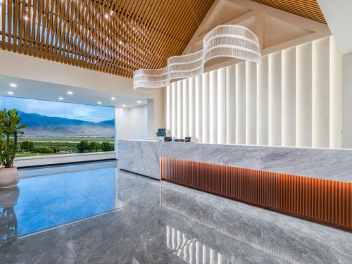 a lobby with a swimming pool and a bar at 遇见托格伦夏营地 in Taxkorgan