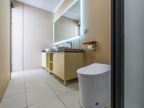 a bathroom with a toilet and a sink at 遇见托格伦夏营地 in Taxkorgan