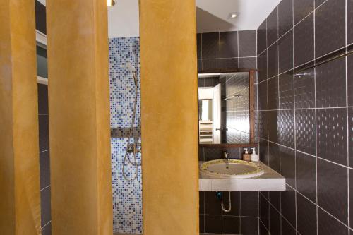 a bathroom with a sink and a mirror at Suksompong Resort in Khao Lak