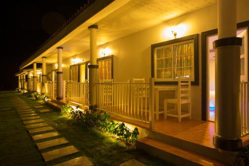 a house with a porch at night with lights at Suksompong Resort in Khao Lak