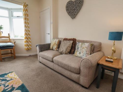 a living room with a couch and a table at North Terrace in Saltburn-by-the-Sea