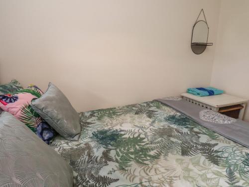 a bed with a blanket and pillows in a room at North Terrace in Saltburn-by-the-Sea