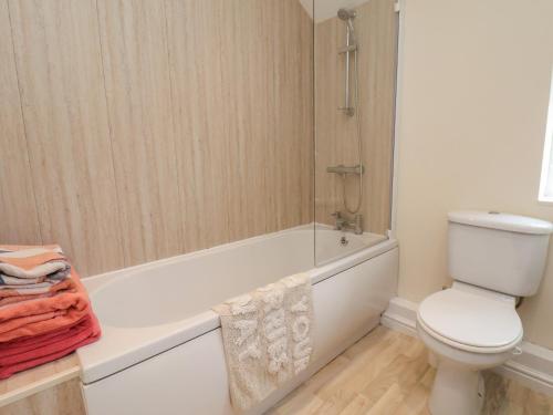 a bathroom with a toilet and a bath tub at North Terrace in Saltburn-by-the-Sea
