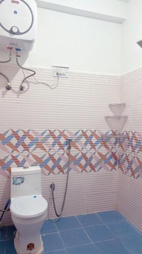 a bathroom with a toilet and a shower at Pine view kasol in Kasol