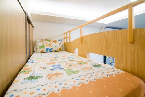 a small bedroom with a bed on a wooden staircase at 宜人生活溜滑梯親子民宿 Easylife B&B in Dongshan