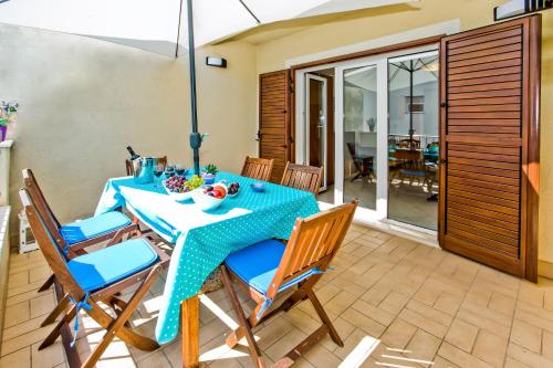 a dining room with a blue table and chairs at Beautiful SeaView Villa in Hvar