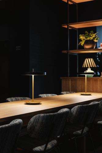 a conference room with a wooden table and chairs at voco Belfast by IHG in Belfast