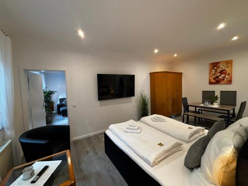 a room with a bed and a living room at Residenz Royal in Sandhausen