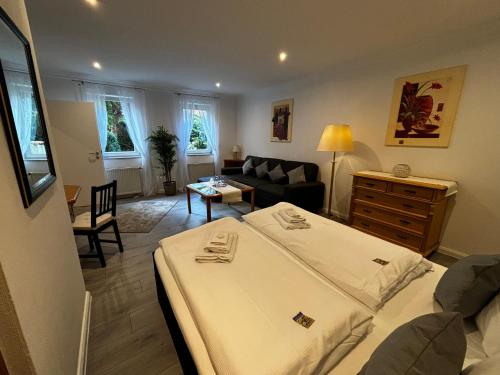 a bedroom with a bed and a living room at Residenz Royal in Sandhausen