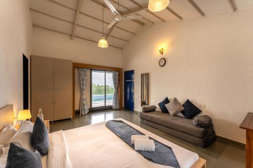 a large living room with a couch and a bed at SaffronStays Le Soil, Igatpuri - pet-friendly villa with viewing deck for panoramic views in Igatpuri