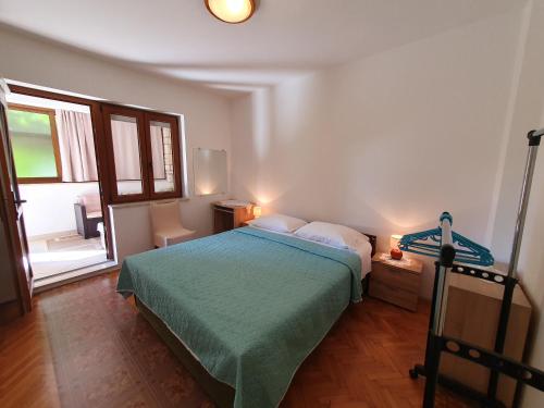 a bedroom with a bed and a large window at RIKY Ap4 - few steps from the beach in Novigrad Istria