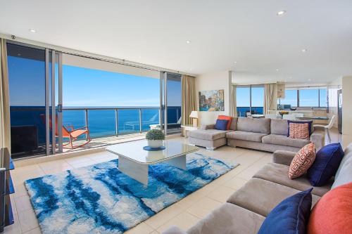 a living room with a view of the ocean at Peninsula Apartments managed by Gchs in Gold Coast