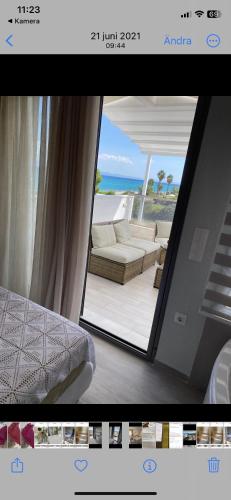 a picture of a living room with a view of the ocean at Villa Theodora in front of the sea in Hanioti