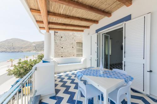 a balcony with blue and white flooring and a table and chairs at Archi Suite Canneto in Canneto