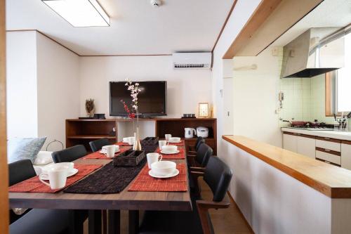 a dining room with a long table with chairs at Daini Kuwamura Building 4th in Tokyo