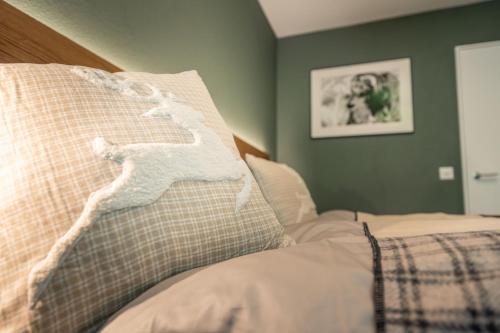 a bedroom with a bed with a pillow on it at Haus Cervino - luxury apartment in Zermatt