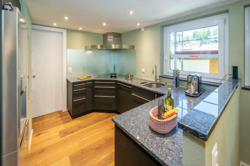 a kitchen with a sink and a counter top at Haus Cervino - luxury apartment in Zermatt