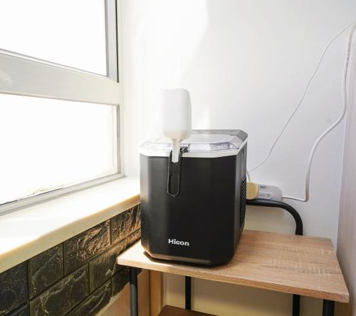 a heater sitting on a table next to a window at The Salvation Army - Booth Lodge in Hong Kong