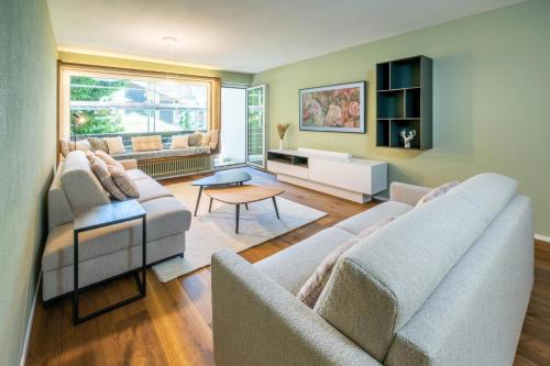 a living room with two couches and a table at Haus Cervino - luxury apartment in Zermatt