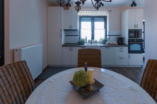 a kitchen with a table with a candle on it at BAB-LAK Apartman in Kisvárda