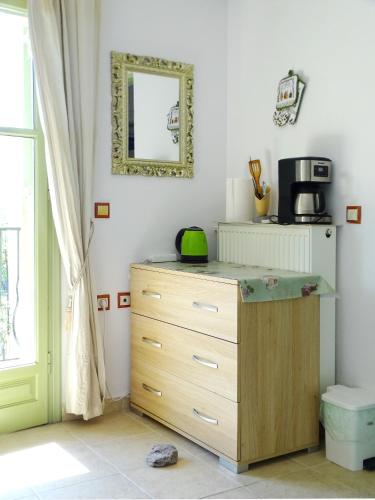 a dresser in a room with a mirror at Marchie's Place - Spacious one bedroom apartment for rent on Skopelos Island in Skopelos Town