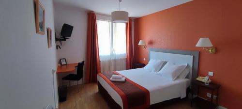 a hotel room with a bed and a window at Logis Grand Hotel Pelisson in Nontron