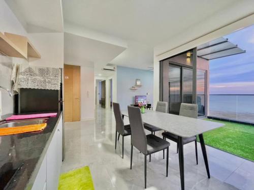 a kitchen and dining room with a table and chairs at Imperio Residence Melaka in Melaka