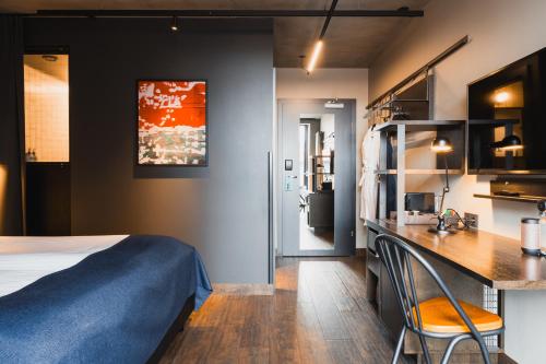 a hotel room with a bed and a desk with chairs at Exeter Hotel in Reykjavík