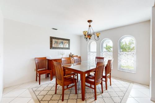 a dining room with a wooden table and chairs at Endless Summer Oasis in Port Charlotte
