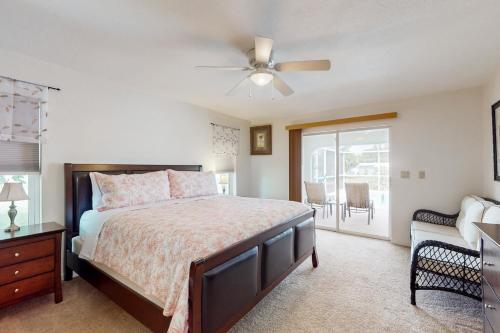 a bedroom with a bed and a ceiling fan at Endless Summer Oasis in Port Charlotte